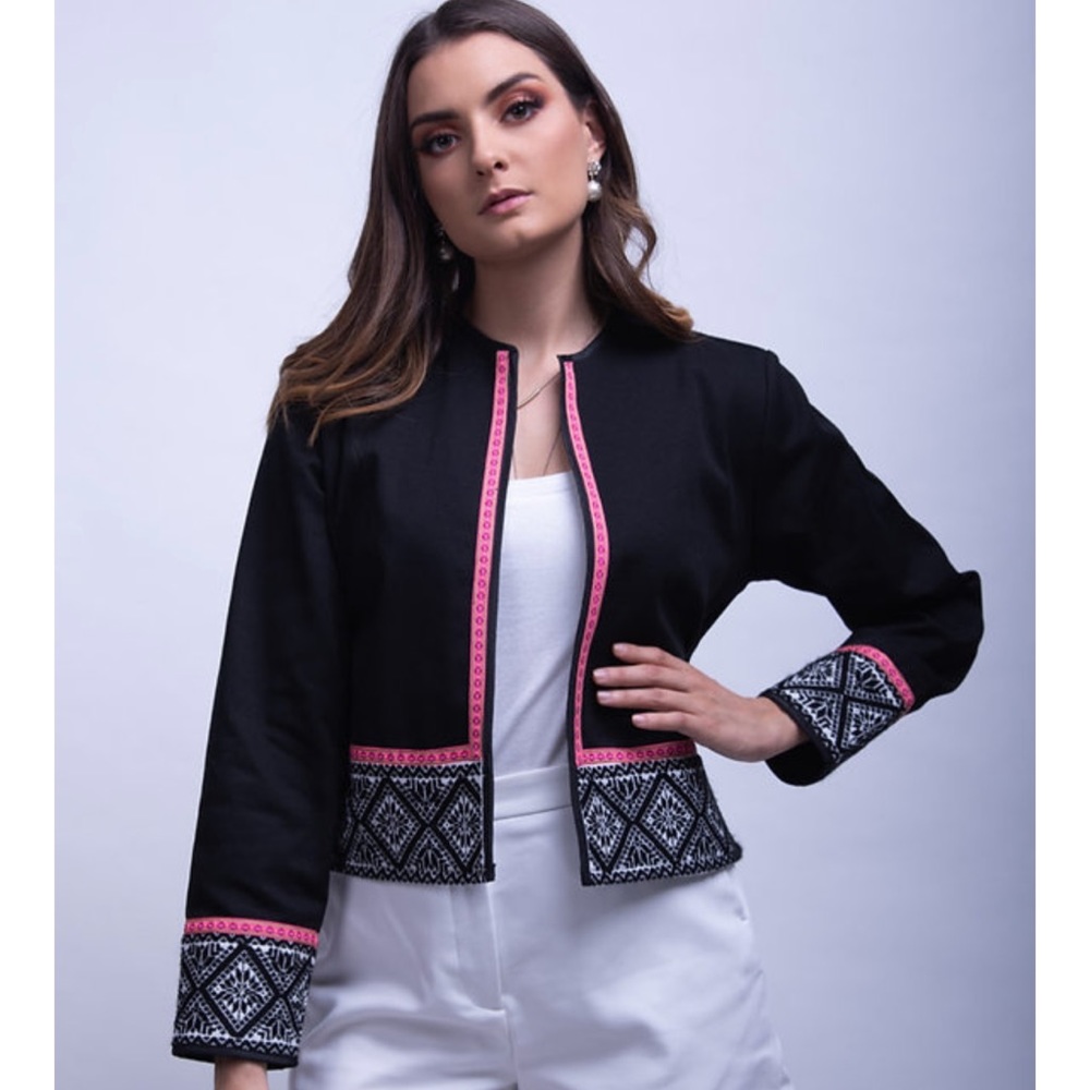 Black jacket with embroidered with traditional patterns and pink details.